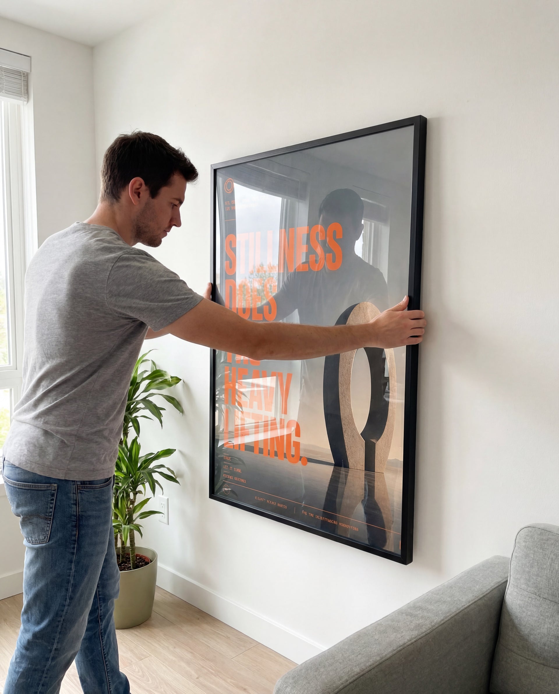 Man hanging Rizen framed wall art on white wall